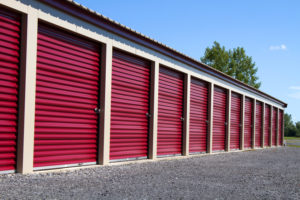 A row of mini rental units for temporary self storage in an outdoor setting.