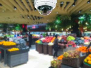 camera security in shopping mall with supermarket blur background.