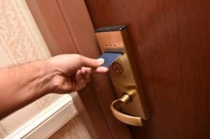 Man opens the door of his hotel room with an electronic key-card