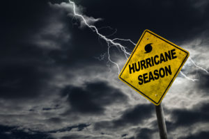 Hurricane season with symbol sign against a stormy bacdrop